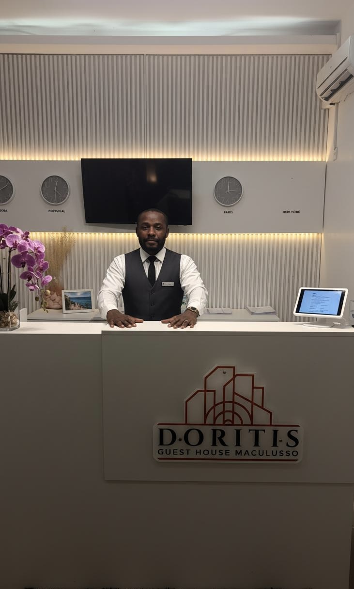 Receptionist at Doritis Guest House welcoming guests