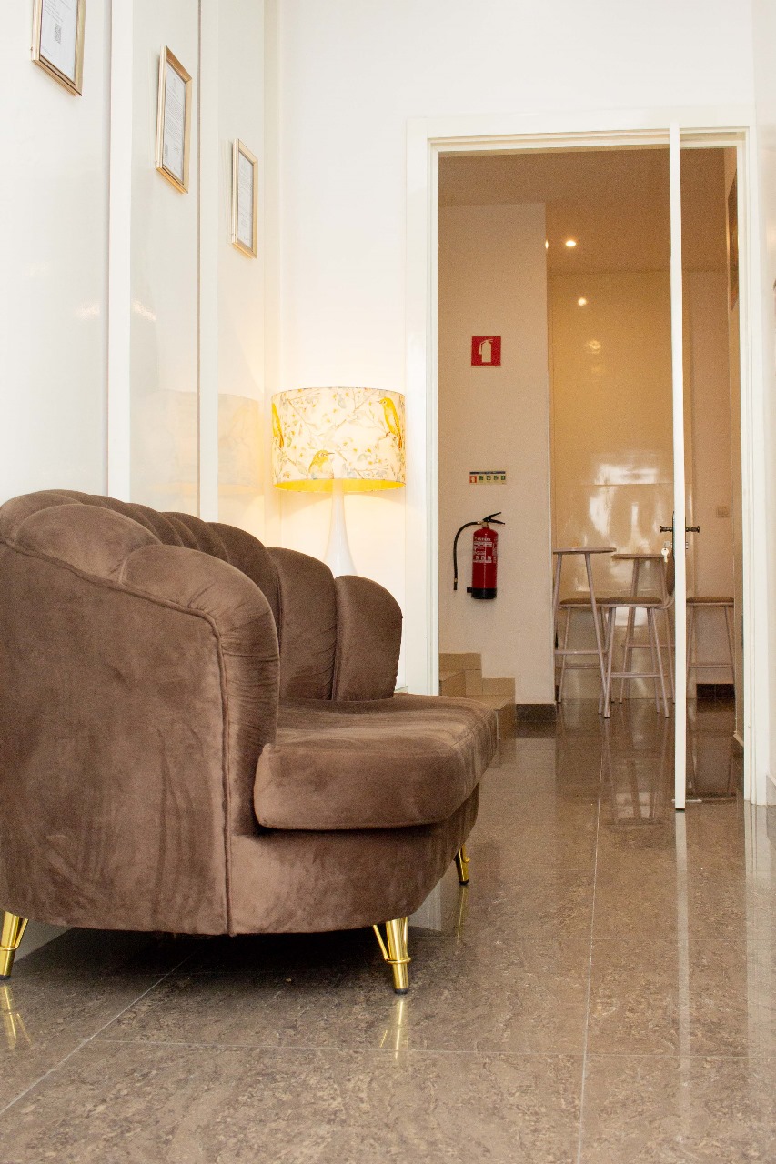 Cozy modern lobby with brown couch and soft lighting