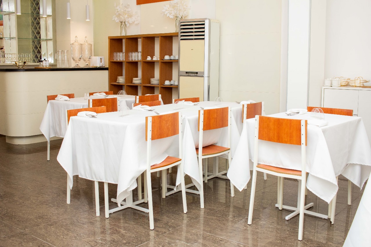 Empty restaurant interior with neatly arranged tables and chairs